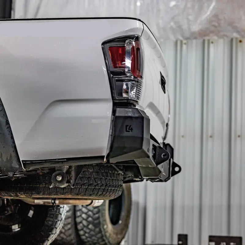 Tacoma Overland Rear Bumper for 3rd Gen 2016+ with high clearance design and integrated hitch, installed on a white TRD 4x4 Off-Road Tacoma.