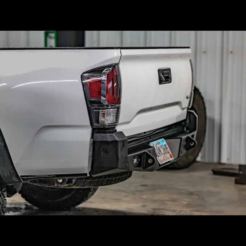 Tacoma Overland Rear Bumper with D-Ring tabs and improved departure angle, installed on a 3rd Gen 2016+ white Tacoma TRD 4x4 Off-Road.