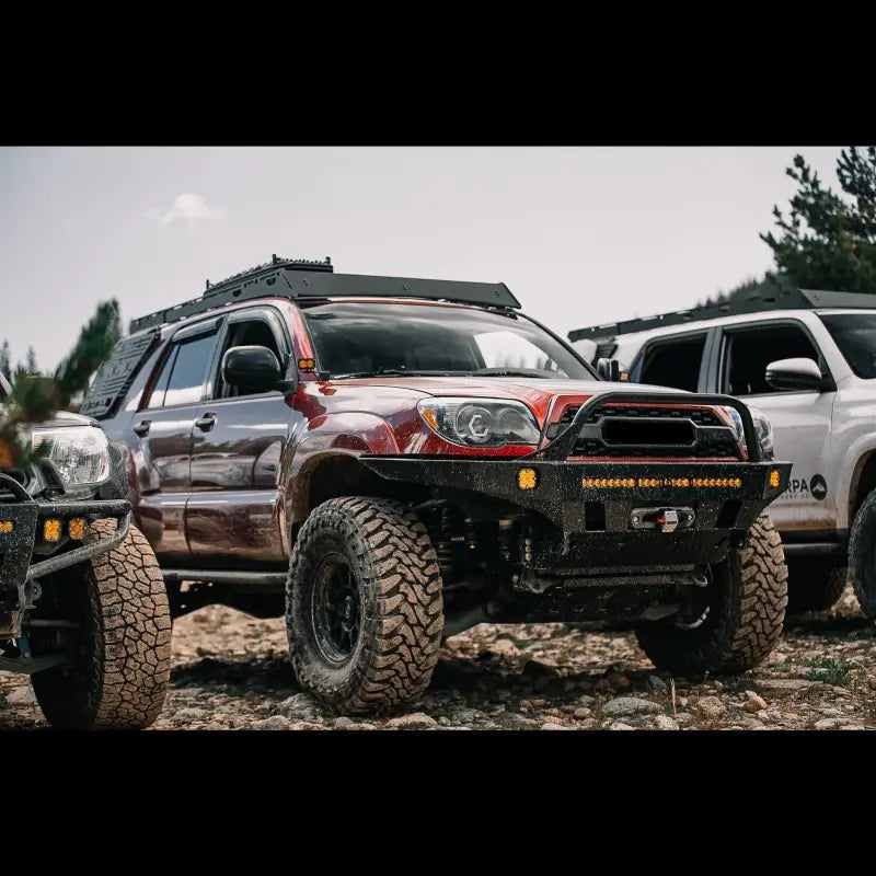 2003-2009 Toyota 4Runner with Overland Series Front Bumper parked alongside other off-road vehicles, emphasizing rugged design.