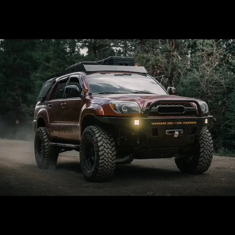 4th Gen 4Runner equipped with Overland Series Front Bumper, driving on a dirt road, highlighting off-road capability and protection.