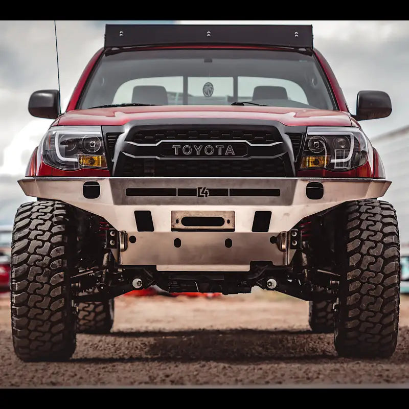 Head-on view of a red Toyota Tacoma with Tacoma Overland Series front bumper, showcasing its no-weld installation and off-road readiness.
