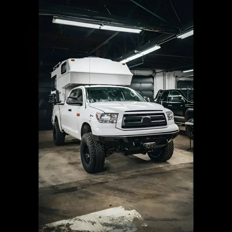 Side angle of a white Tundra equipped with Overland Series front bumper, ideal for off-road use with light bar and sensor compatibility.