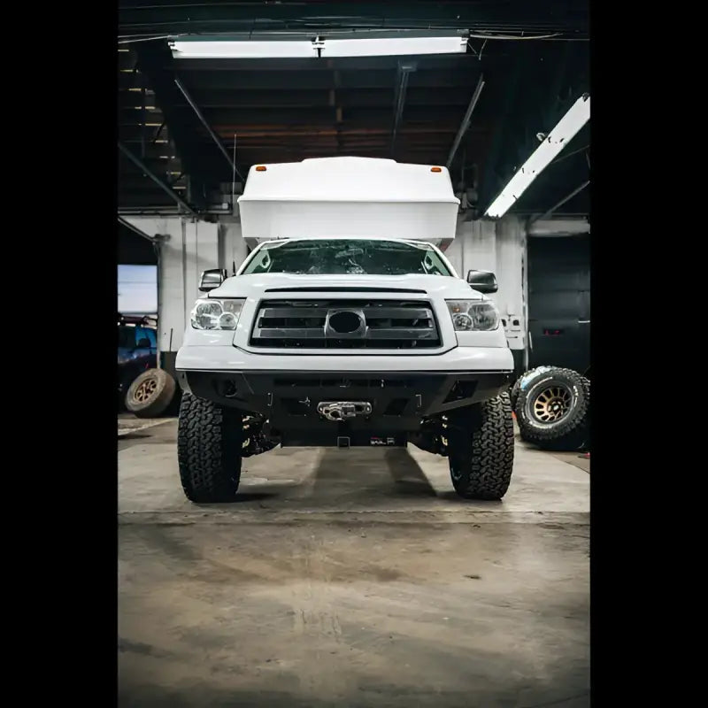 Front view of a white 2nd Gen Tundra with Overland Series front bumper, showcasing winch fitment and rugged design.