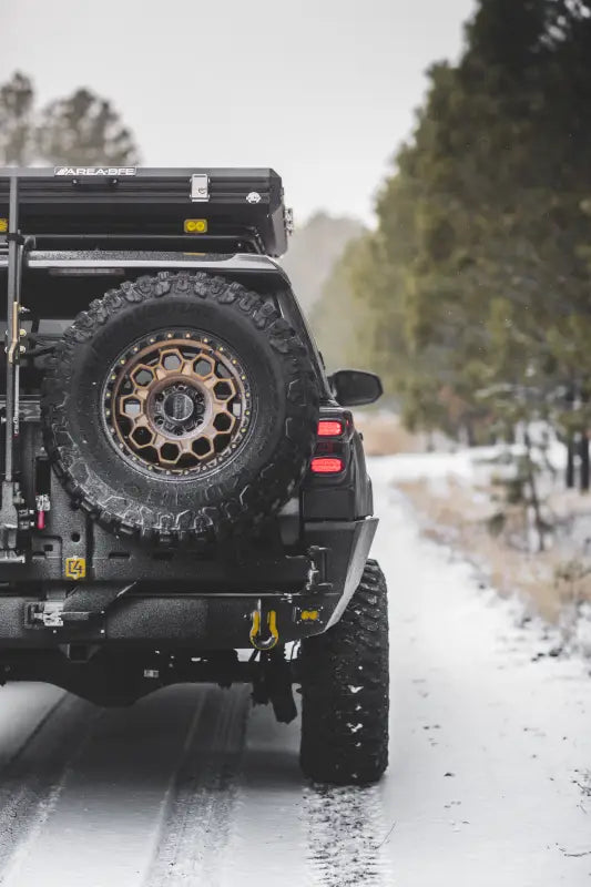 Black off-road vehicle with roof tent featuring Overland Series Rear Bumper for 4Runner