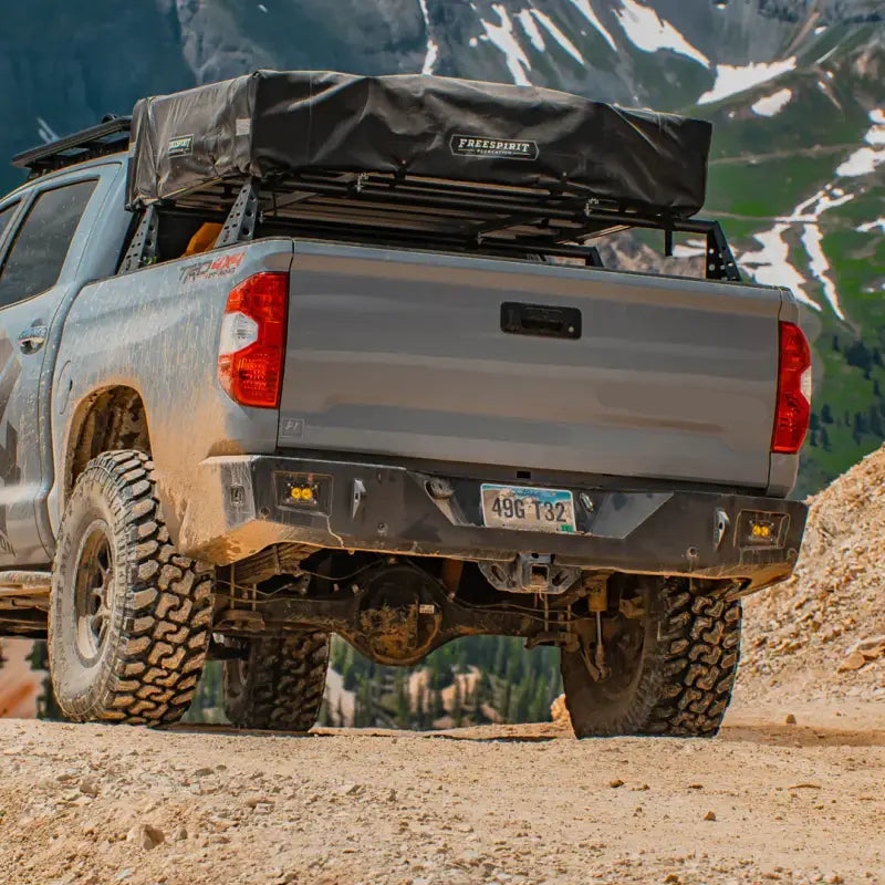 Tundra Overland Rear Bumper on 2nd Gen 2014-2021 truck, steel construction with D-ring mounts and light cutouts, off-road setting.