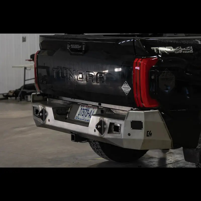 Tundra Overland Rear Bumper for 2022+ models in raw steel finish, featuring reverse lights and sensor support, mounted on black truck.