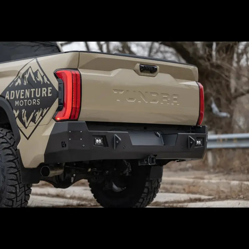 Tundra Overland Rear Bumper for 2022+ models in black steel, featuring reverse lights and OE hitch compatibility, mounted on beige truck.
