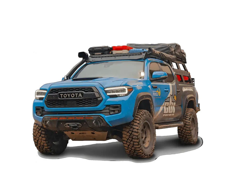 Blue Toyota Tacoma equipped with Prinsu Cab Rack and desert air intake, featuring off-road modifications and cargo setup.
