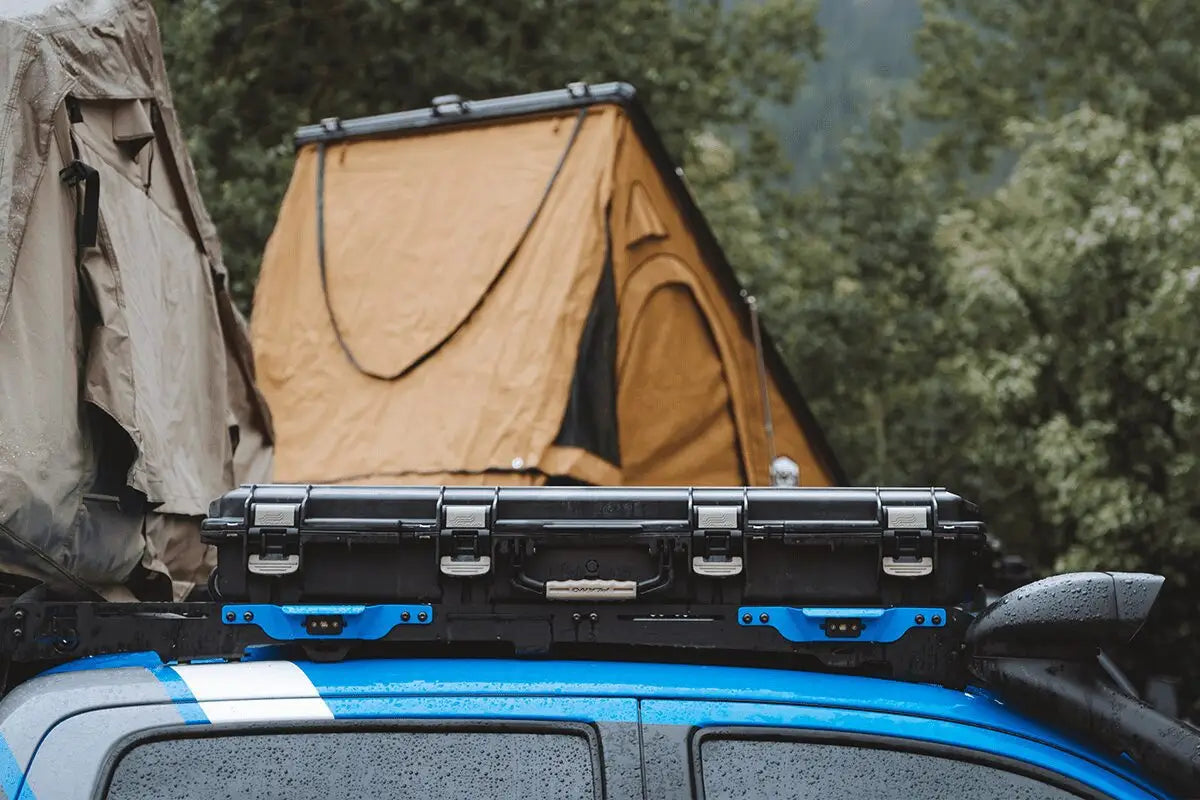 Close-up of Prinsu Cab Rack on Toyota Tacoma with mounted storage cases and camping gear, highlighting low-profile design.