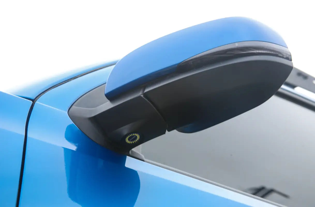 Puddle Pods installed on a blue Tacoma side mirror, showcasing OEM fit and LED light integration.