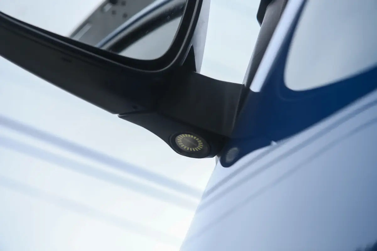 Underside view of Tacoma side mirror with Puddle Pods LED light installed, highlighting bright illumination.