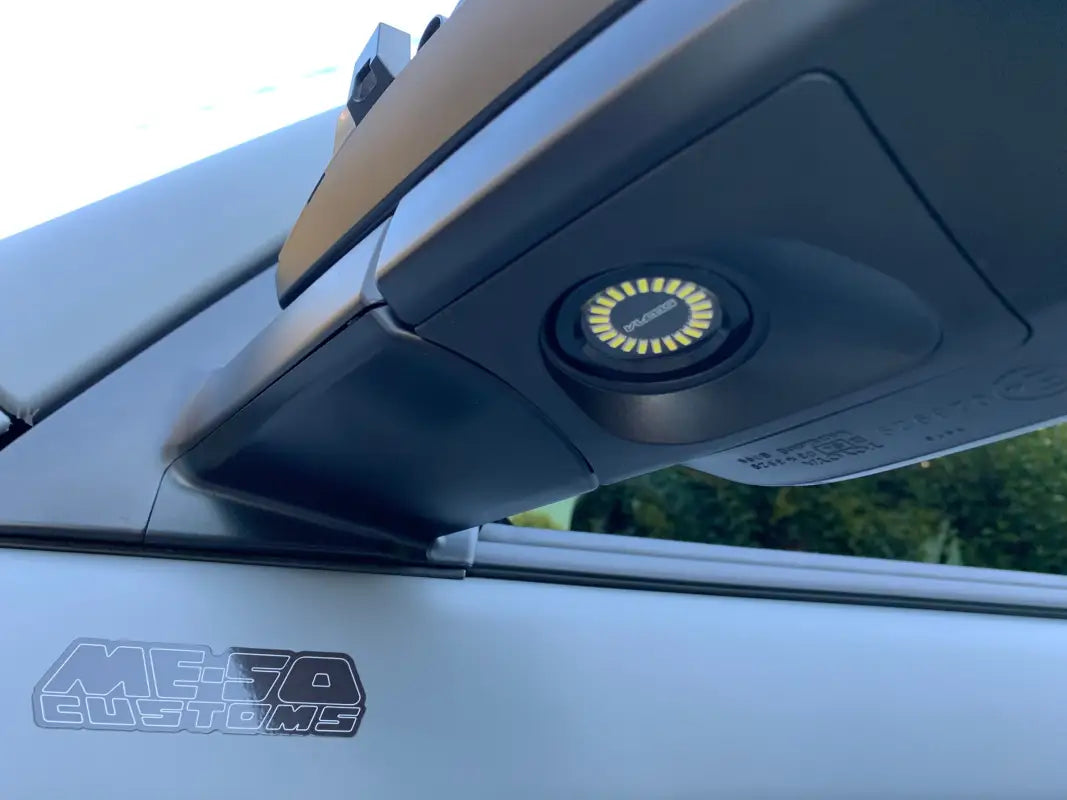 4 Runner Puddle Pods installed under a side mirror, providing bright illumination for enhanced visibility.