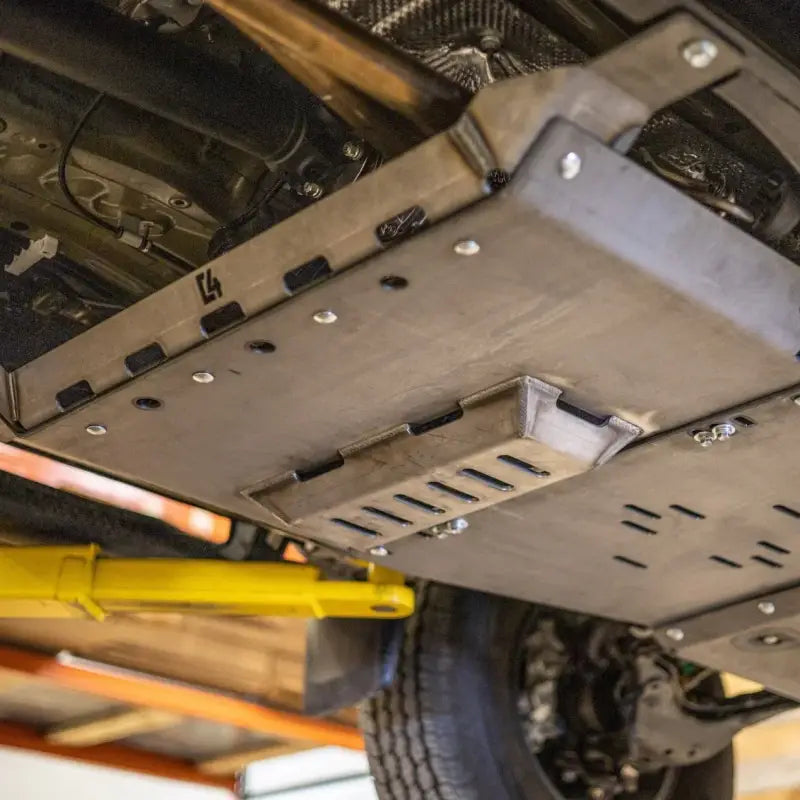 Tacoma rear skid plates for 2nd and 3rd gen models, 2005+, shown installed on vehicle undercarriage. Steel construction with bolt-on design.