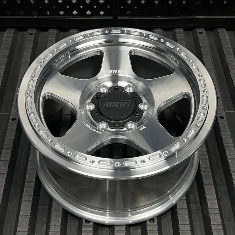 Silver alloy monoforged series wheel with black center cap and embossed ABS design