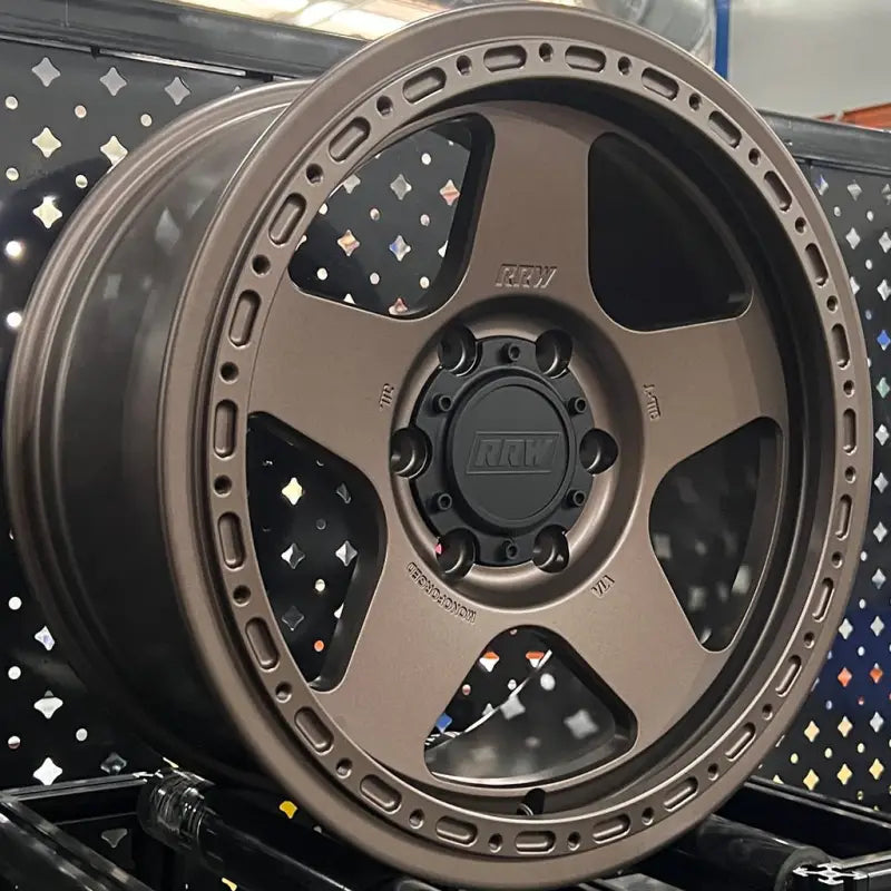 Bronze-colored monoforged series wheel with five spokes, decorative rim, and embossed ABS