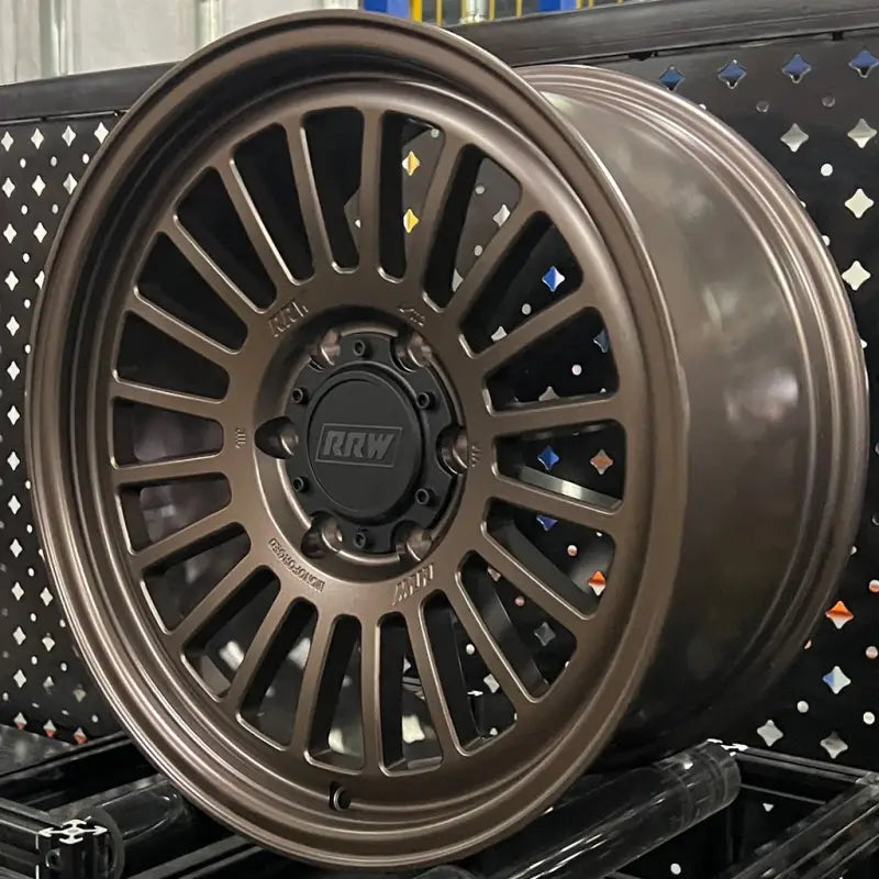Bronze-colored monoforged series wheel with multi-spokes, lug nuts, and center caps