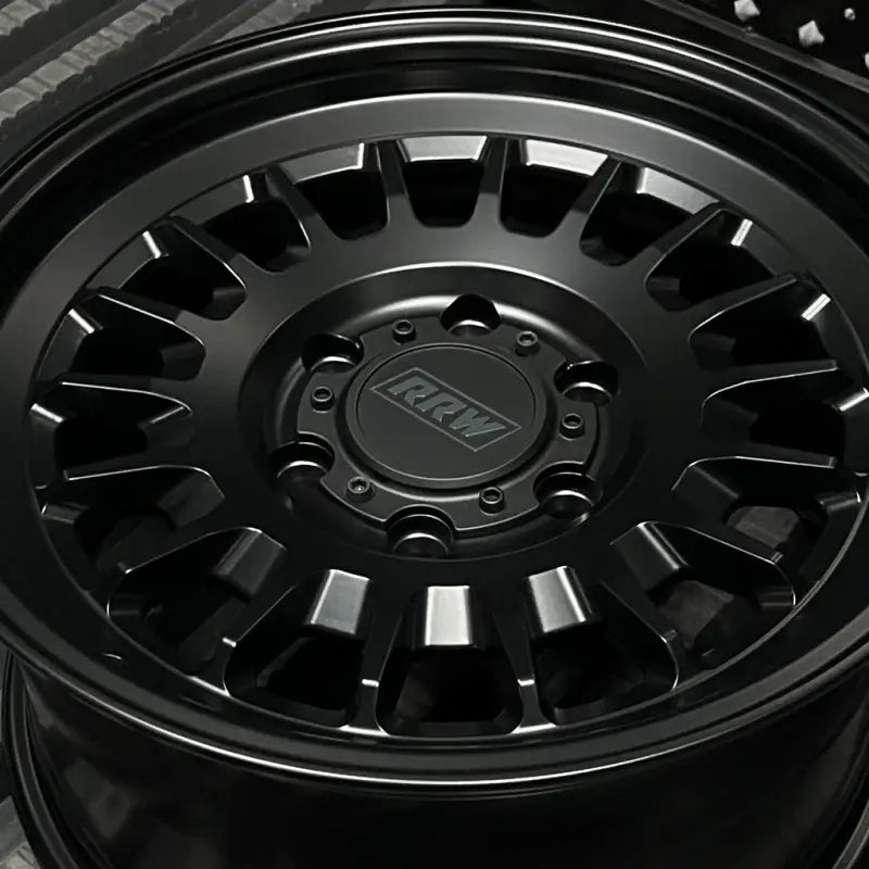 Black alloy wheel from RG7-S MonoForged Series with lug nuts and center caps