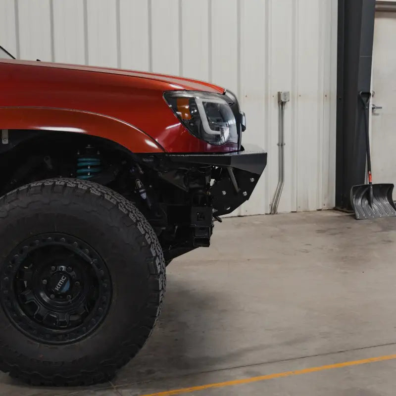 Side profile of a Toyota Tacoma with the Rock Runner front bumper, emphasizing its modular design and off-road readiness.