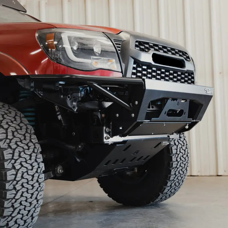 Detailed angled view of the Tacoma Rock Runner bumper showing the skid plate and reinforced structure for 2005-2015 models.