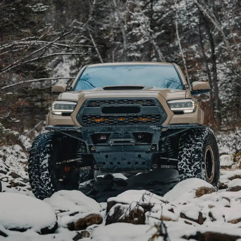 2016+ Tacoma with Rock Runner Front Bumper in snowy terrain, featuring durable steel construction and modular design.