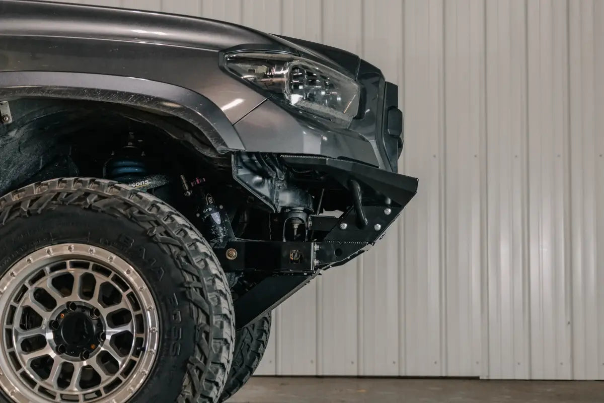 Side view of a 2016+ Tacoma with Rock Runner skid plate and cross member delete, highlighting rugged off-road armor and fitment.