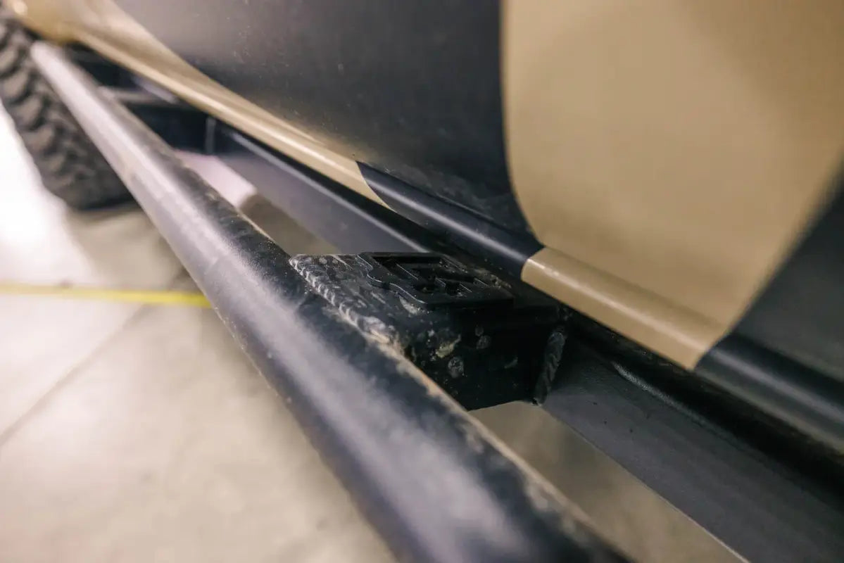Detailed view of Tacoma Rock Runner Sliders' mounting hardware, highlighting sturdy bolt-on installation for 2016+ models.