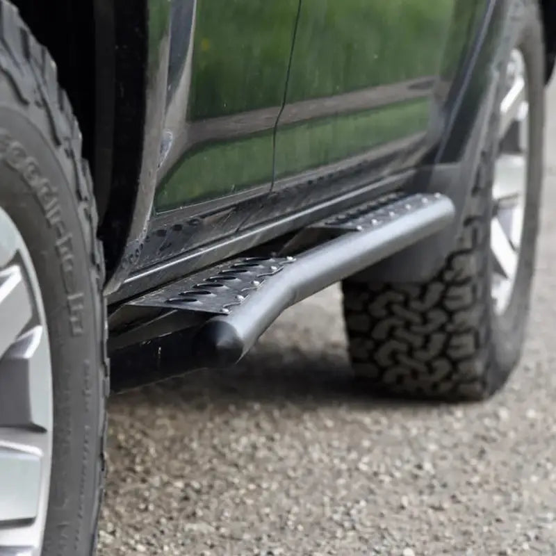 Detailed view of 4Runner rock sliders on a 5th Gen 2014+ vehicle, showing textured step surface and robust steel tubing.