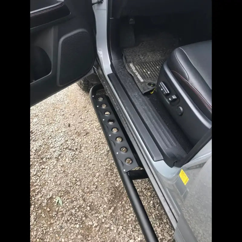 Side view of 4Runner rock sliders installed on a 5th Gen 2014+ vehicle, showcasing easy access step functionality and rugged design.