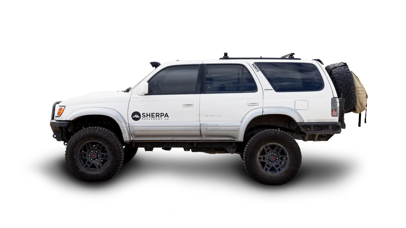 White SUV with Roof Track Load Bars installed, showcasing a low-profile universal rack system for carrying cargo and adventure gear.