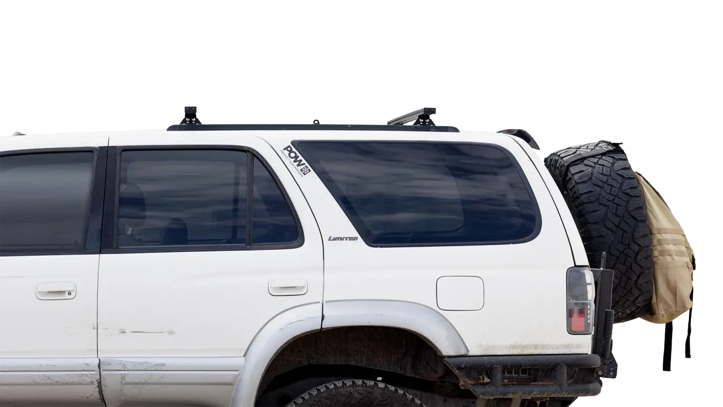 Close-up of a white SUV with Roof Track Load Bars mounted, highlighting the practical and sleek design for roof storage solutions.