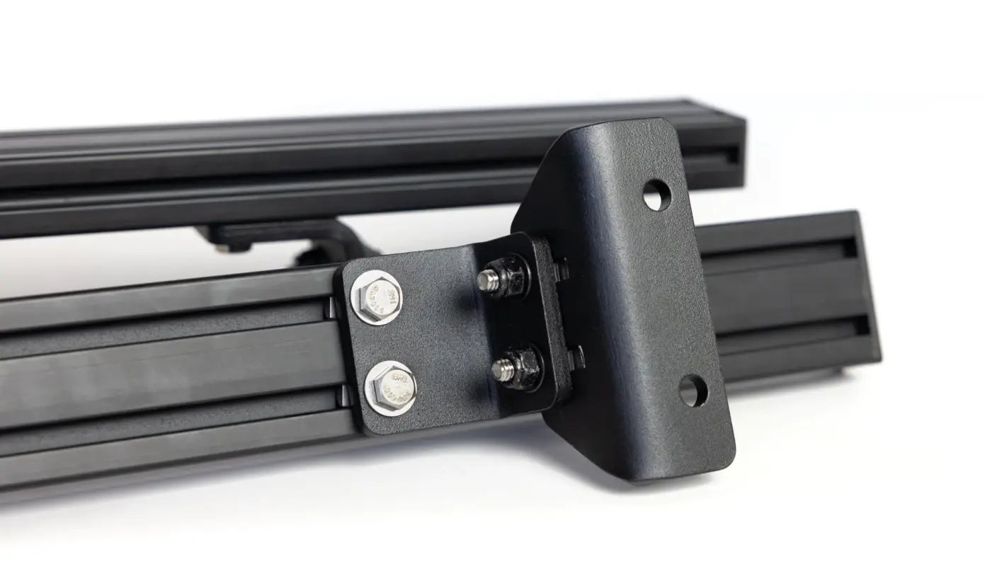 Detailed view of the mounting feet and bolts of the Roof Track Load Bars, emphasizing secure and durable installation.