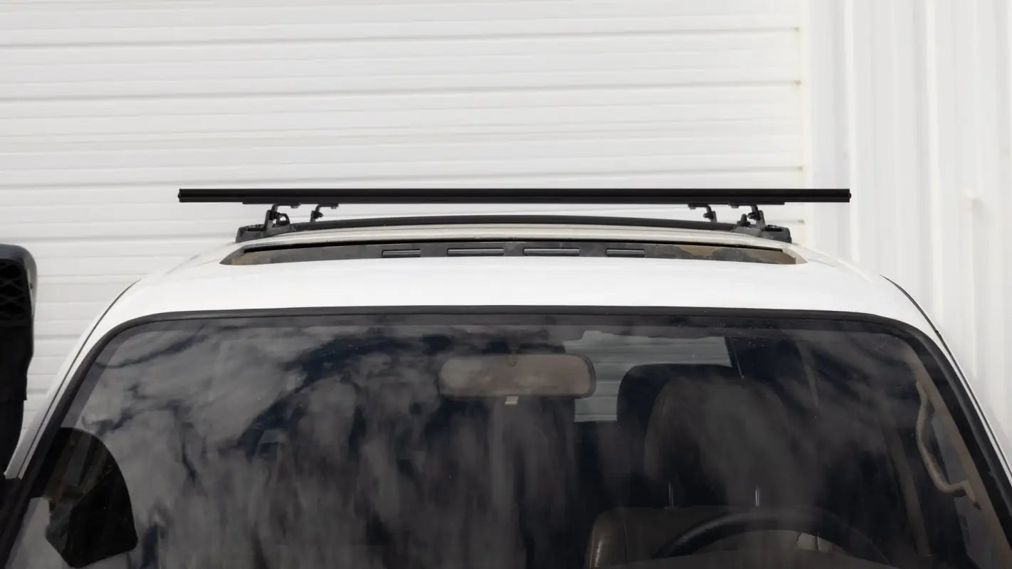 Front view of Roof Track Load Bars installed on a vehicle roof, illustrating the sleek and functional design for cargo carrying.