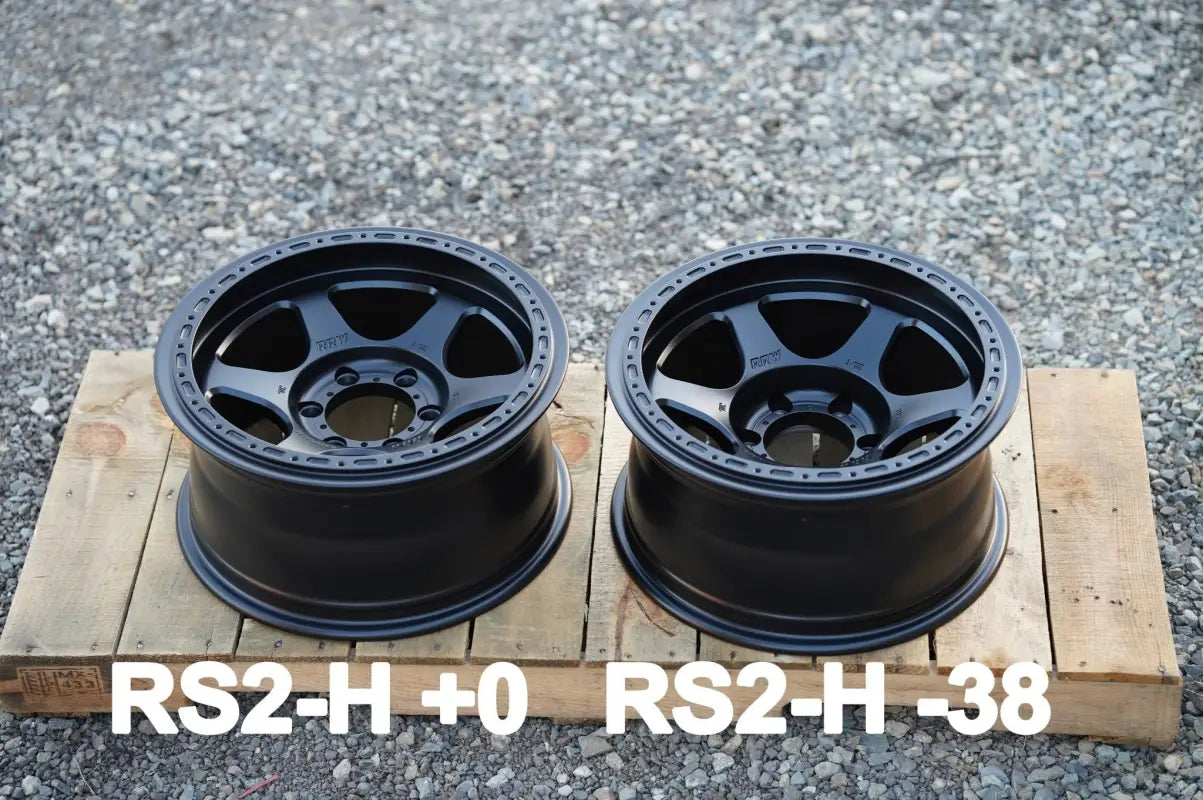 Two black RS2-H Hybrid MonoForged Wheel rims with lug nuts from the Monoforged Series