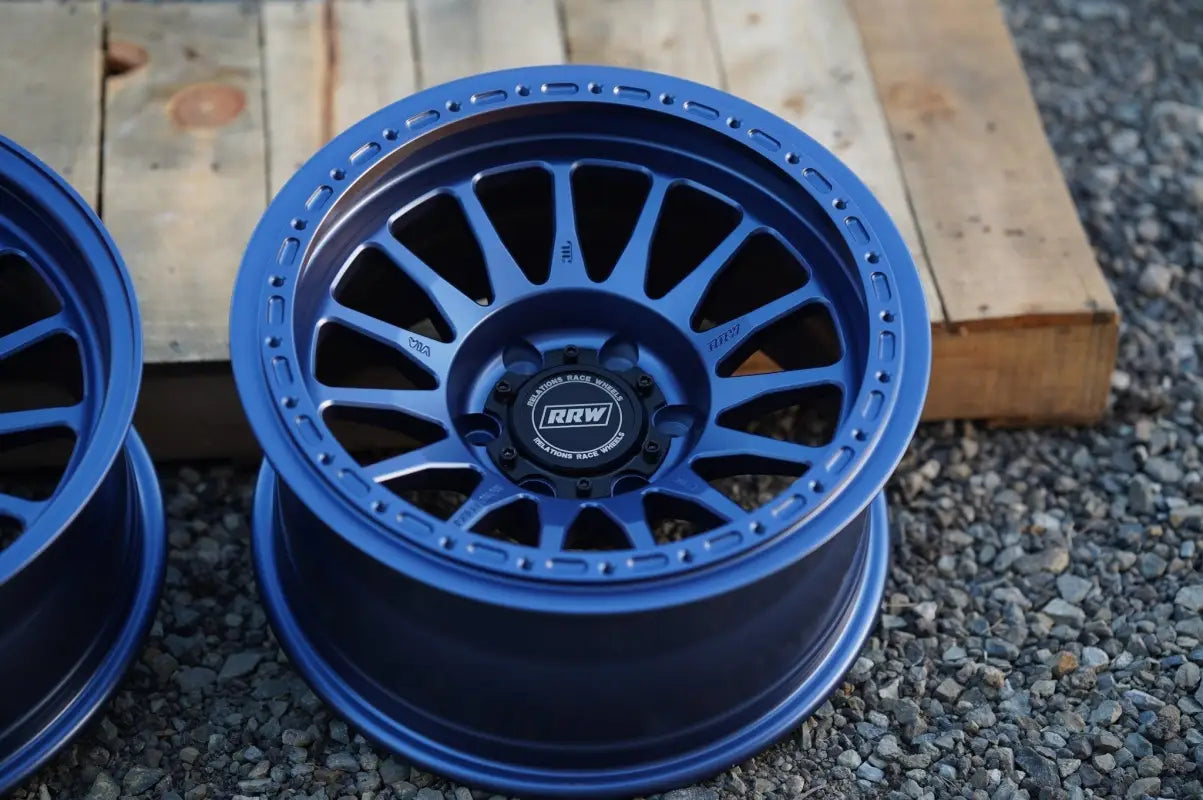 Blue off-road wheel from RS7-H Hybrid MonoForged Series with lug nuts and center caps