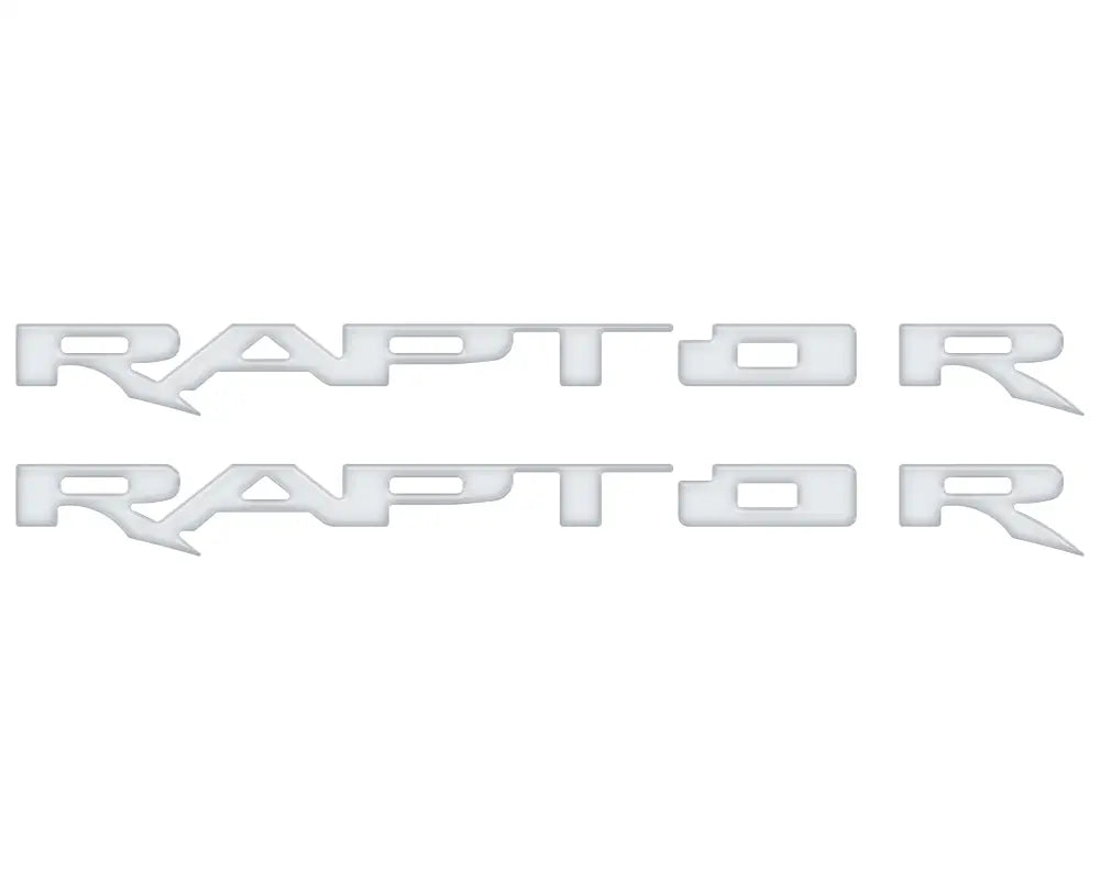 Two silver Raptor emblem overlays for running board emblems on Ford Raptor trucks