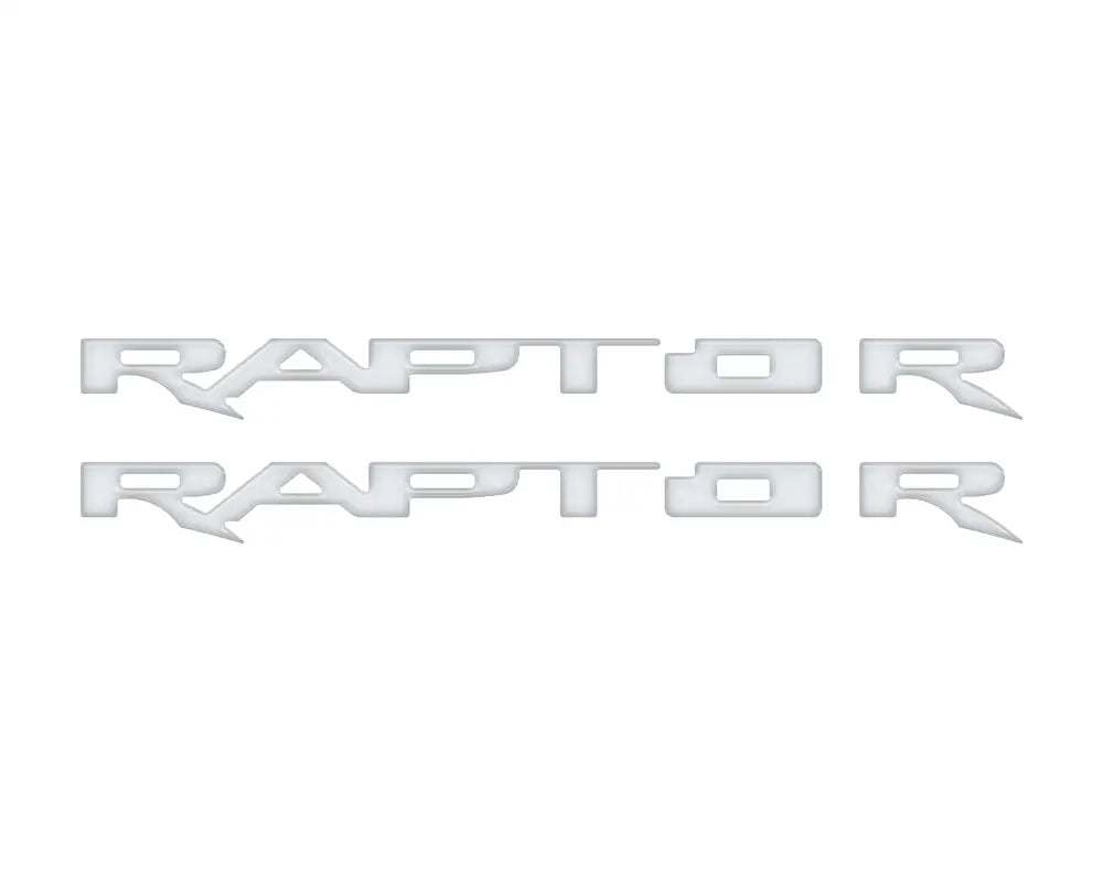 Two silver RAPTOR emblem overlays for running board installation on Ford Raptor
