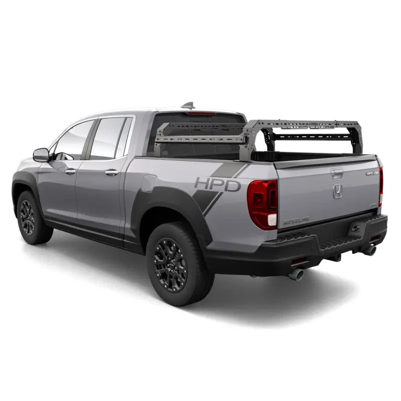 Honda Ridgeline truck equipped with a modular mid-height cargo rack system, 800 lbs capacity, ideal for overlanding and bed storage.