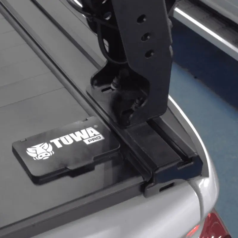 Close-up of Shiprock Mid Height Rack mounted on T-slot rail with TUWA Pro base, showcasing sturdy attachment for bed rack systems.