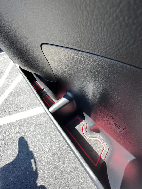 Close-up of side door cubby foam inserts with red trim in a 2010-2024 Toyota 4 Runner, designed for style and functionality.