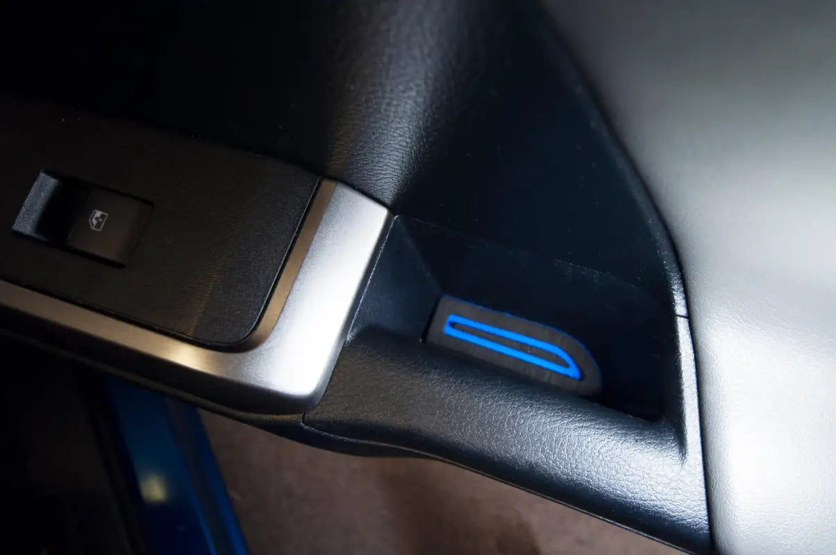 Close-up of a compact side door pocket cup holder insert with blue detailing, tailored for 2016-2023 Toyota Tacoma interiors.