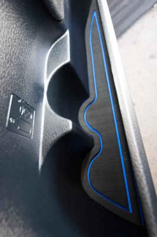 Detailed view of a side door pocket cup holder insert with blue trim, perfectly fitted in a 2016-2023 Toyota Tacoma.