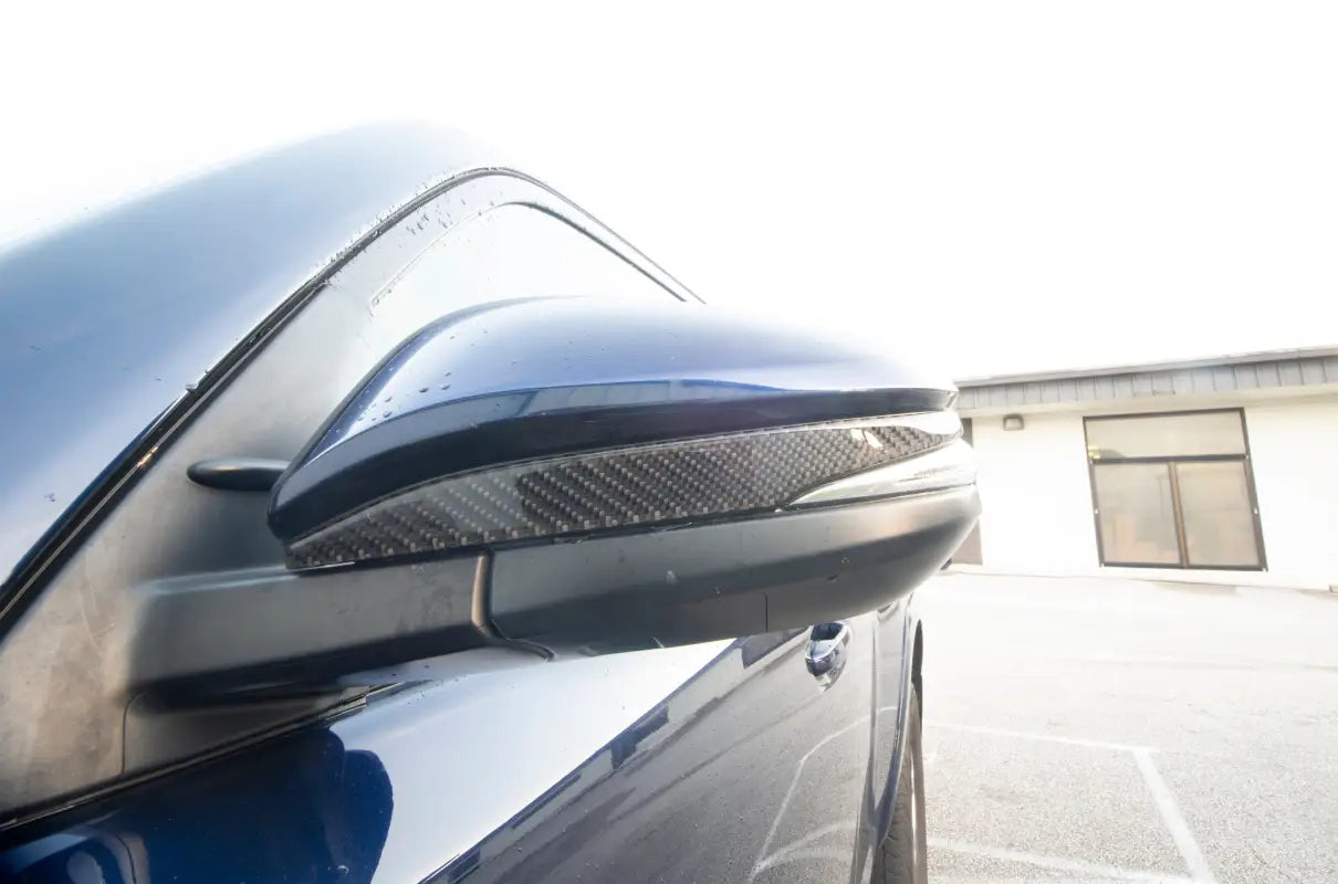 Detailed view of a Toyota 4Runner side mirror featuring a sleek carbon fiber accent trim, designed for 2009-2024 models.