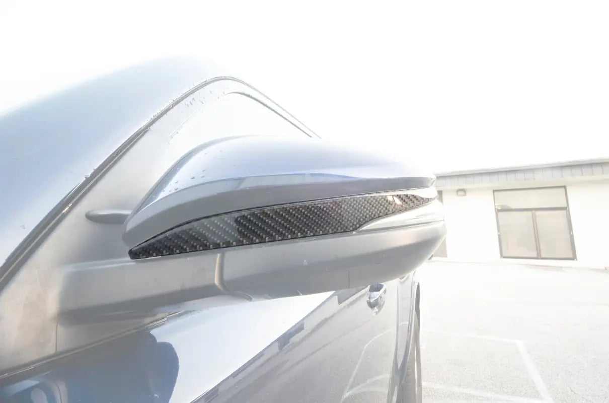 Close-up of a blue Toyota 4Runner side mirror with a carbon fiber accent trim, compatible with 2009-2024 models, enhancing vehicle decor.