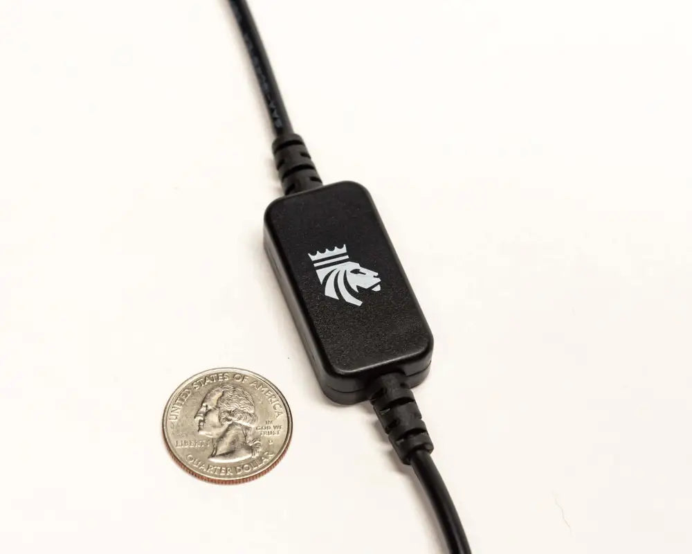 Smart LED dimmer switch next to a US quarter for size comparison, highlighting its small, portable design for 12V lighting.