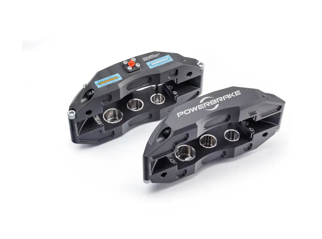 Pair of PowerBrake 6 piston calipers in grey with visible piston chambers for Jeep Wrangler JL 2019+ big brake kit.