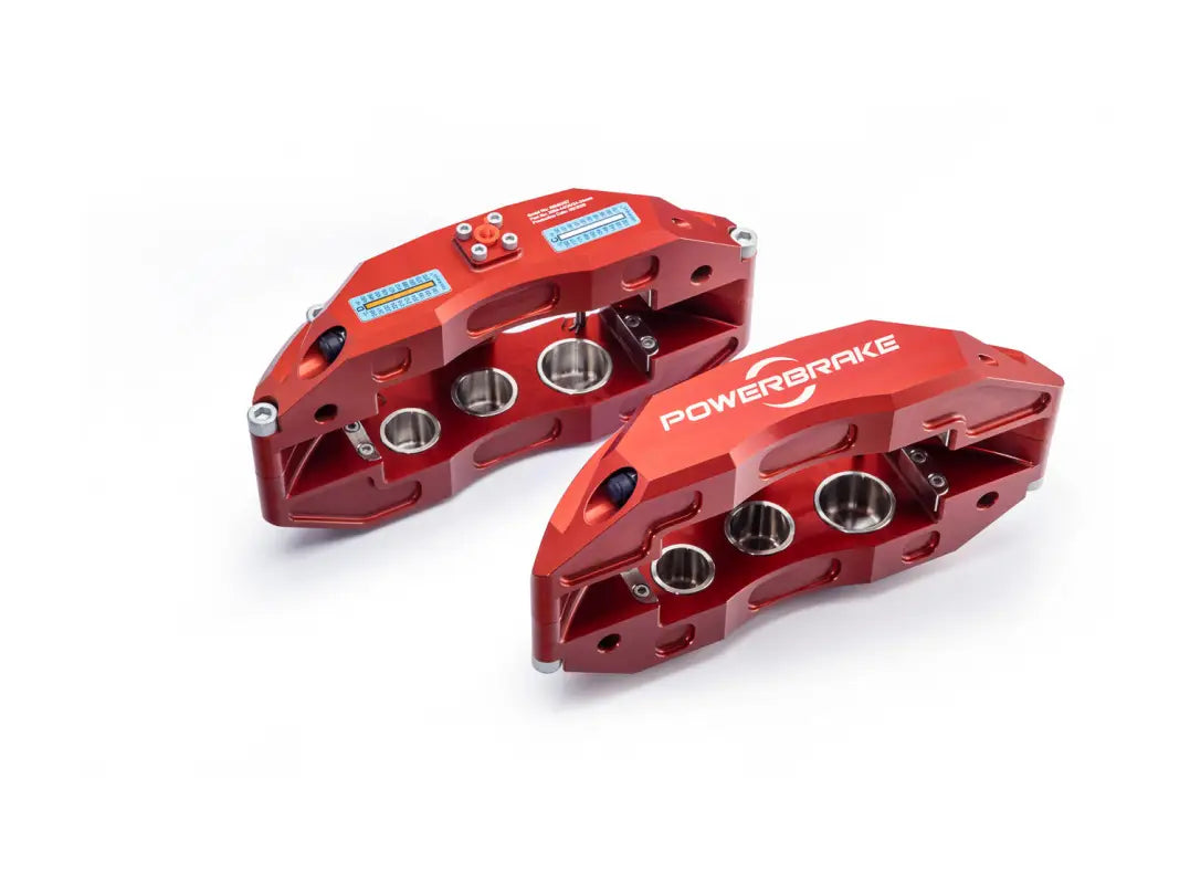 Pair of red 6 piston calipers from the LX570 Big Brake Kit Stage 1, showcasing their precision engineering and Powerbrake branding.