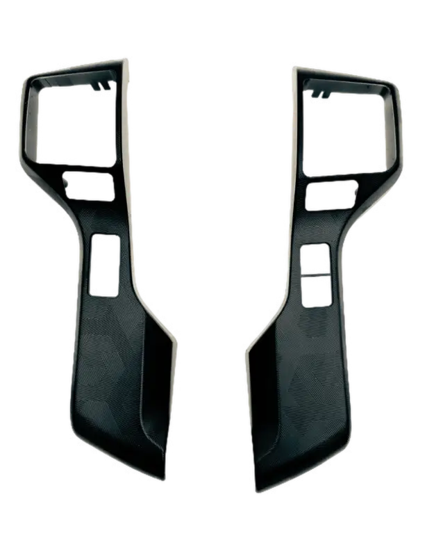 Rear view of steering wheel blackout surround inserts for 2016-2023 Toyota Tacoma, showcasing textured detailing.