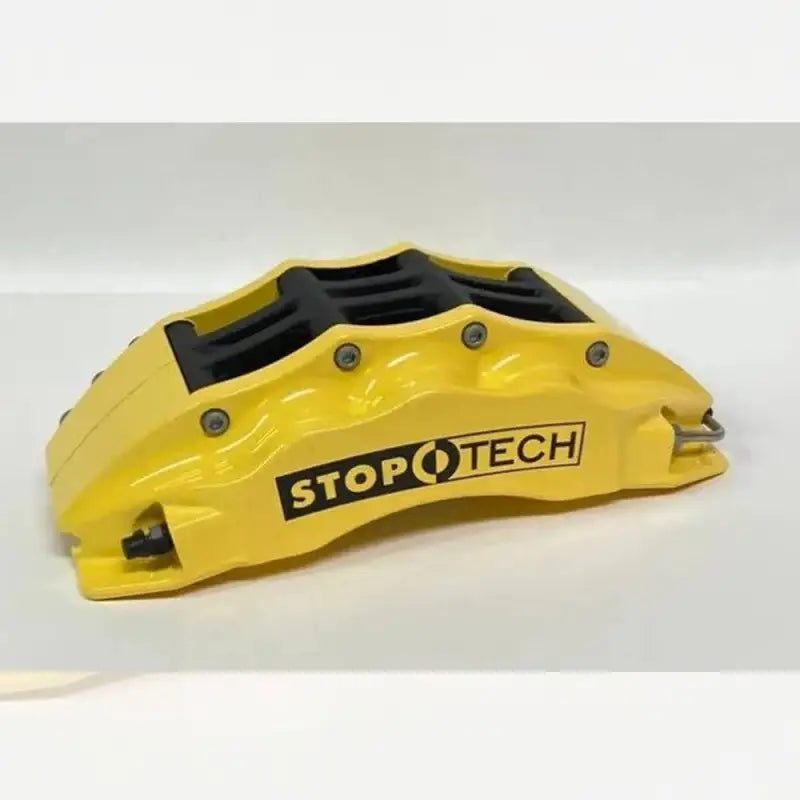 Yellow StopTech 6-piston caliper for Toyota Tacoma, providing a vibrant look and enhanced braking performance.