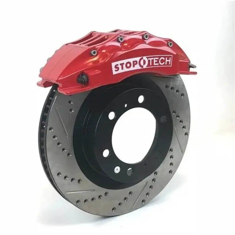 Drilled and slotted rotor with red StopTech 6-piston caliper for Toyota Tacoma, designed for superior braking power.
