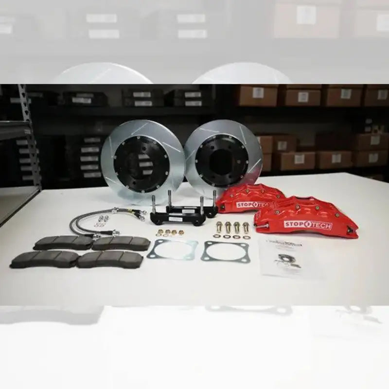 Complete Toyota Tacoma big brake kit including rotors, red calipers, brake pads, brackets, and hardware for performance upgrade.